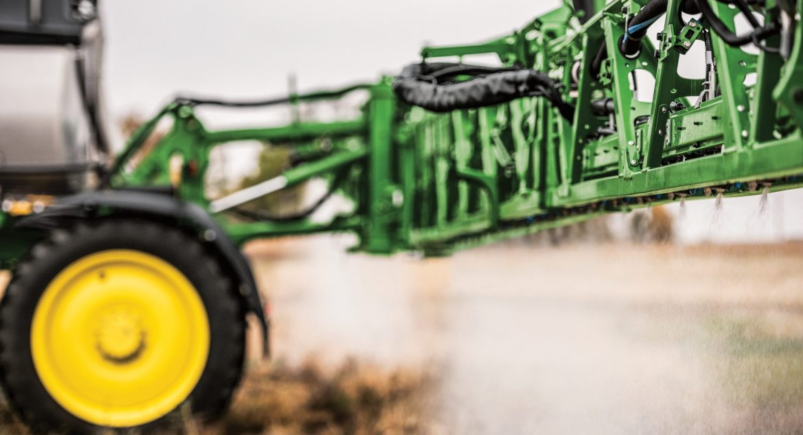 A photo of a John-Deere-412R-Self-Propelled-Sprayer with a close-up look of it its Spraying Nozzles as its sprays