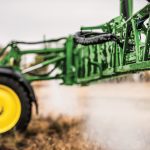 A photo of a John-Deere-412R-Self-Propelled-Sprayer with a close-up look of it its Spraying Nozzles as its sprays