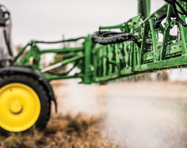 A photo of a John-Deere-412R-Self-Propelled-Sprayer with a close-up look of it its Spraying Nozzles as its sprays