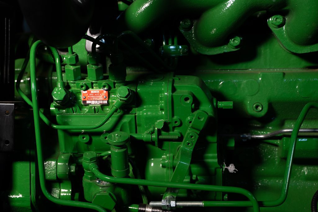 A close-up photo of the engine of a John Deere 5050D tractor.