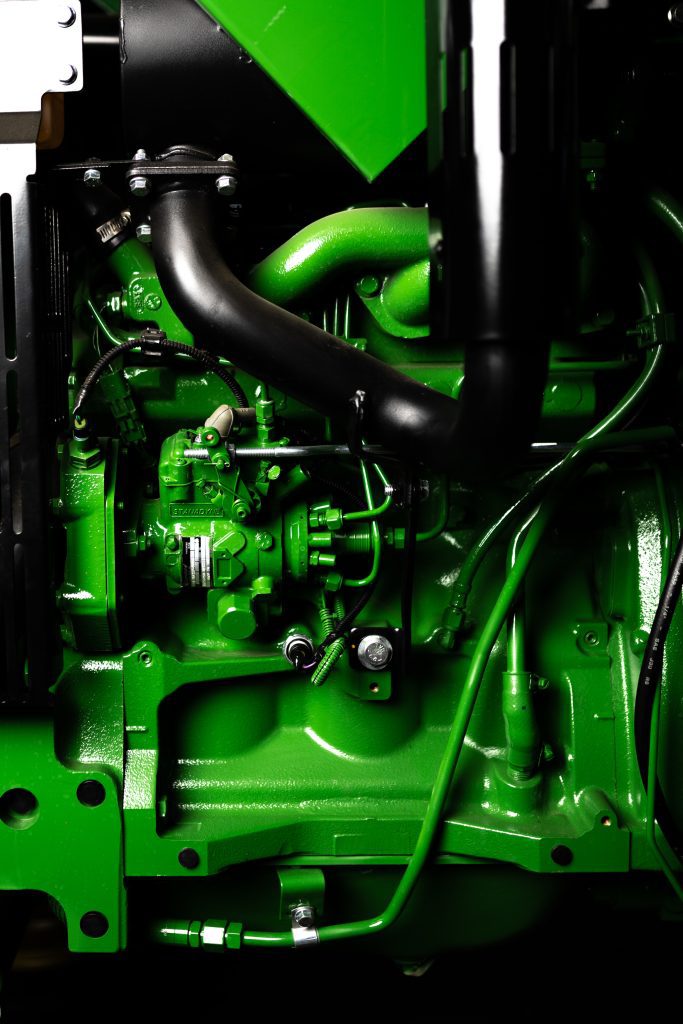 Another close-up photo of the engine of a John Deere 5055E tractor.