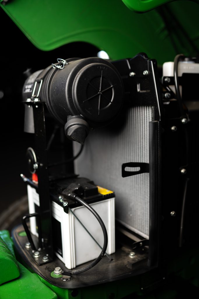 A close-up photo of the engine of a John Deere 5055E tractor.