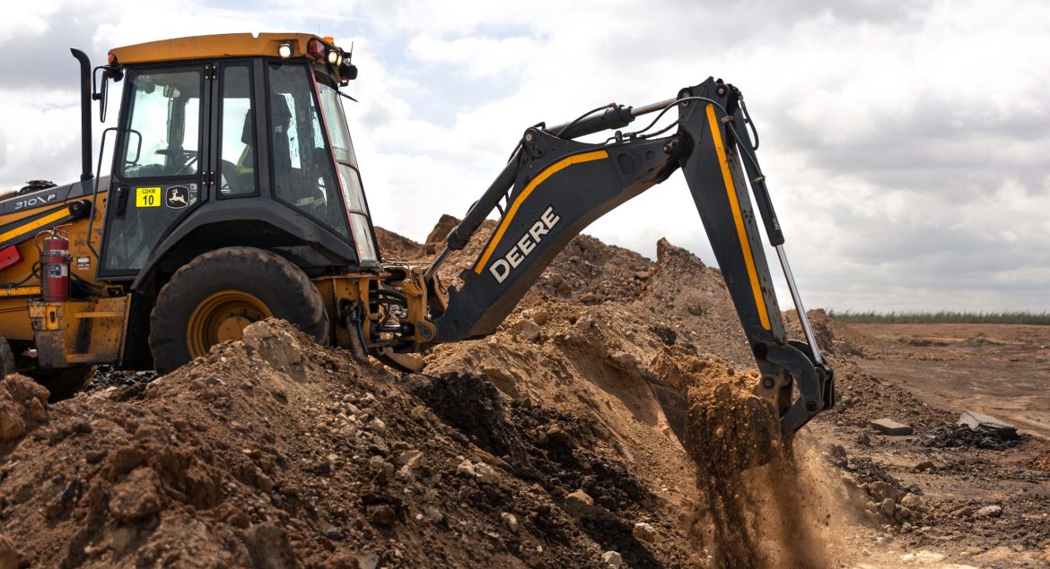 John Deere 310 P-Tier TLB working on site digging