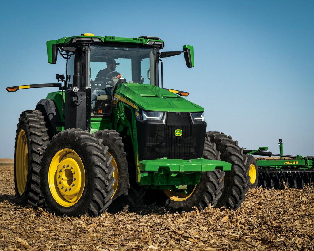 A John Deere 8R 540 tractor working in a field