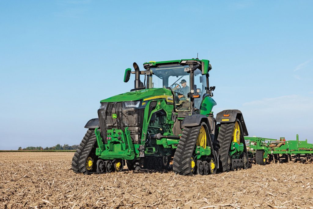 A John Deere 8RX 540 tractor working in a field