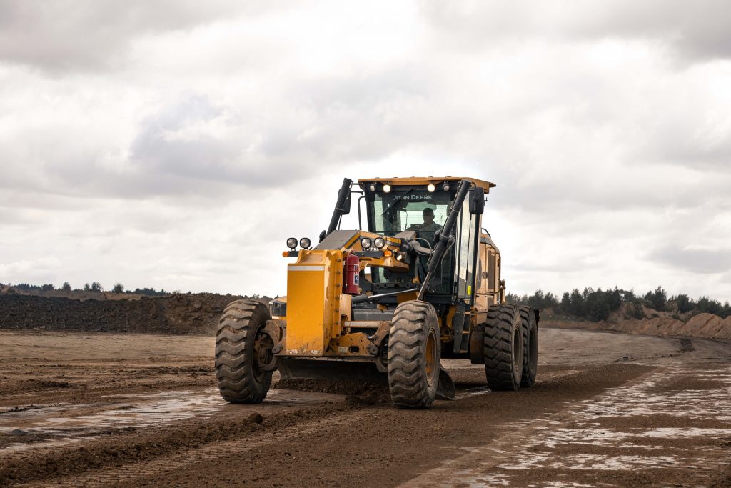 John Deere 620 P-Tier Motor Grader at a mining site.
