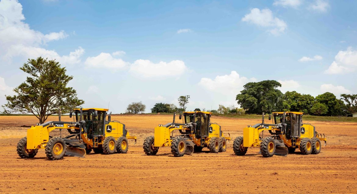 John Deere motor graders line-up, ready to perform precision grading on a road construction project.