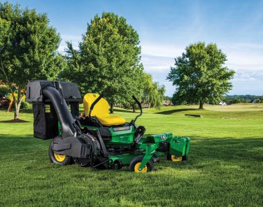 John Deere ZTrak zero turn mower parked on the grass on a well-maintained lawn.