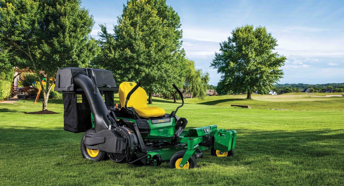 John Deere ZTrak zero turn mower parked on the grass on a well-maintained lawn.