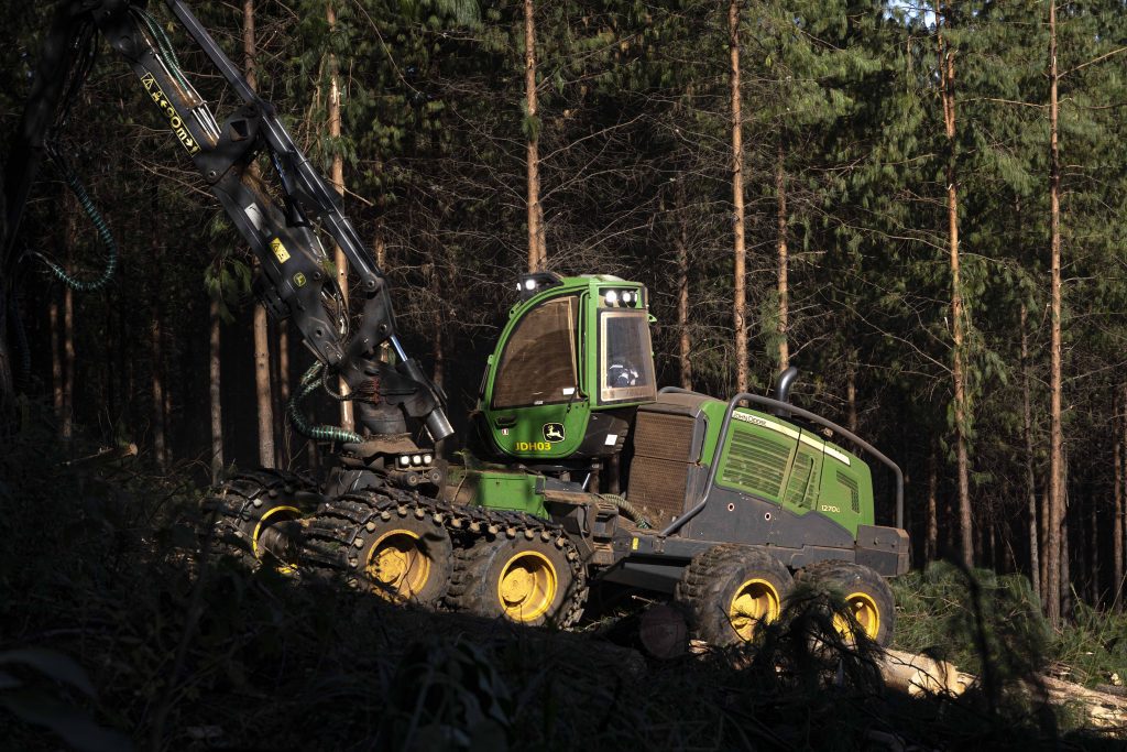 John Deere 1270G 8-wheel drive harvester working in a forestry operation.
